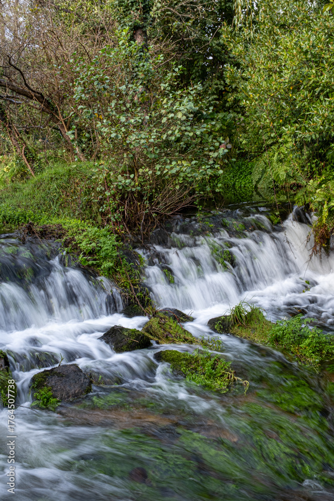 Fototapeta premium Waterfall flowing between rock formations