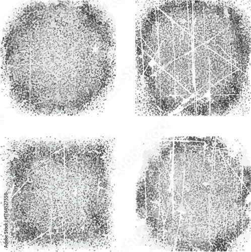 A collection of four isolated black and white grunge texture shapes.