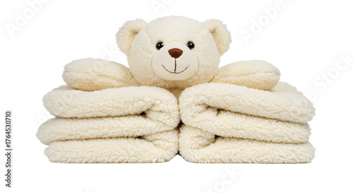 BABY TOYS - Soft beige teddy bear sitting on neatly folded beige towels, cozy fabric texture, perfect for baby care and nursery decor