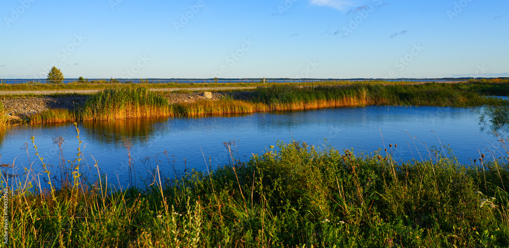 Fototapeta premium Pond on the Väinatamm, the largest causeway in Estonia that connects the islands of Muhu and Saaremaa across the Väike Strait in the Baltic Sea