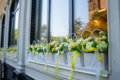 Colorful flower arrangements adorn windows in a quaint shop
