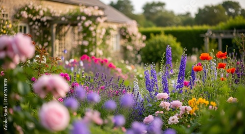 Blooming garden colorful flowers with house in background, showing beautiful backyard maintenance concept and floral decor for spring season.