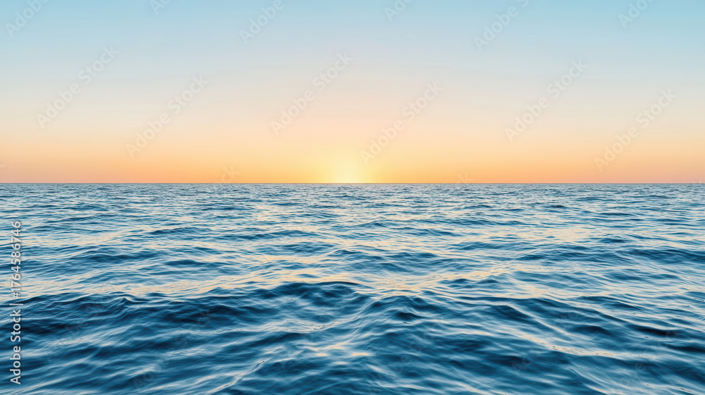 Fototapeta premium Serene ocean waves reflect pastel colors at sunset, creating tranquil atmosphere