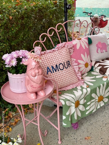 Romantic outdoor decor with pink bench and love themed pillows