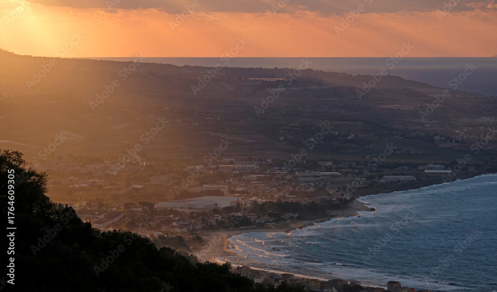 Fototapeta premium Dramatic sky and colors during a sunset at the coast of Italy near Pizzo in Calabria
