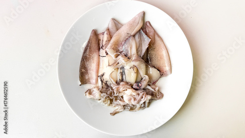 Fotografie Chilled squid artistry elegantly sprawls on porcelain, invoking marine gastronom