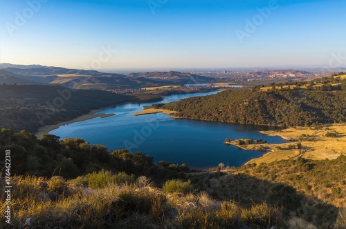 Scenic landscape featuring a lake and nearby rural area in southern Europe