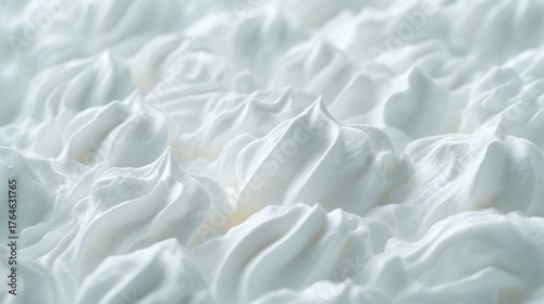 Soft, fluffy peaks of whipped cream create a textured, creamy landscape in white.