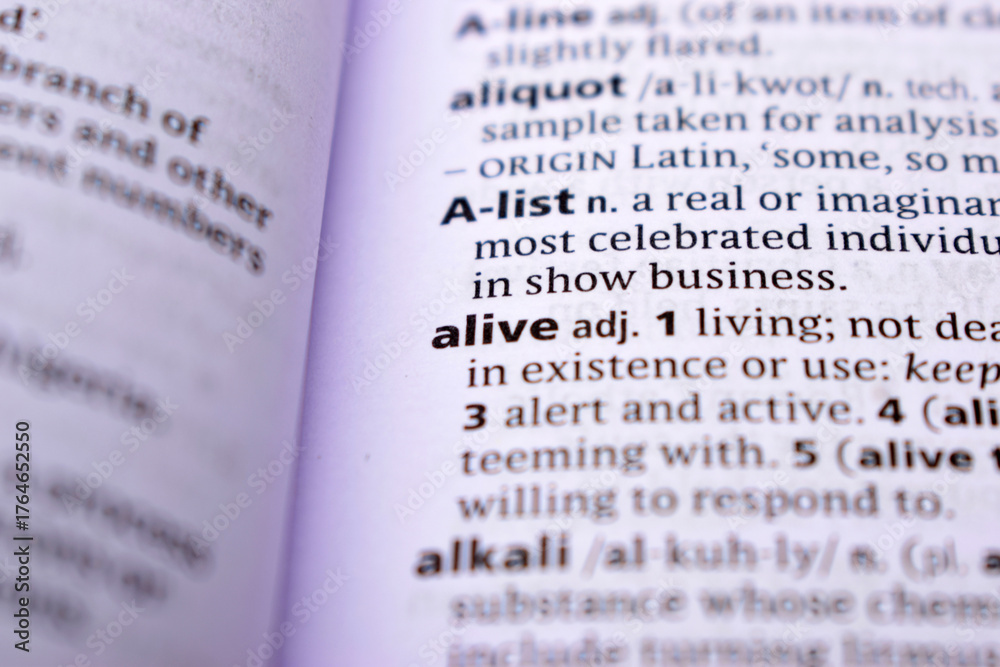 Obraz premium Close Up Of English Dictionary Page With Word - alive