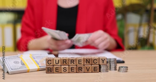 Counting cash and arranging currency reserves at a stylish workspace in the evening light