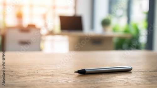 A single pen lying on a wooden desk with blurred background, professional workspace vibe.