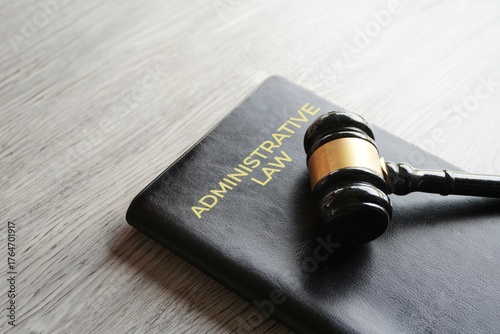 A gavel on a book titled ADMINISTRATIVE LAW. Justice, regulation, and the legal system concept.