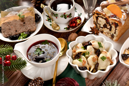 Christmas table with fraditional red borscht with dumplings and other dishes