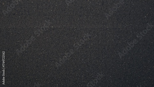 Close-up aerial perspective of freshly laid black tarmac road surface