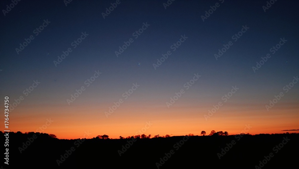 Obraz premium The Sun Sets Beneath The Night Sky