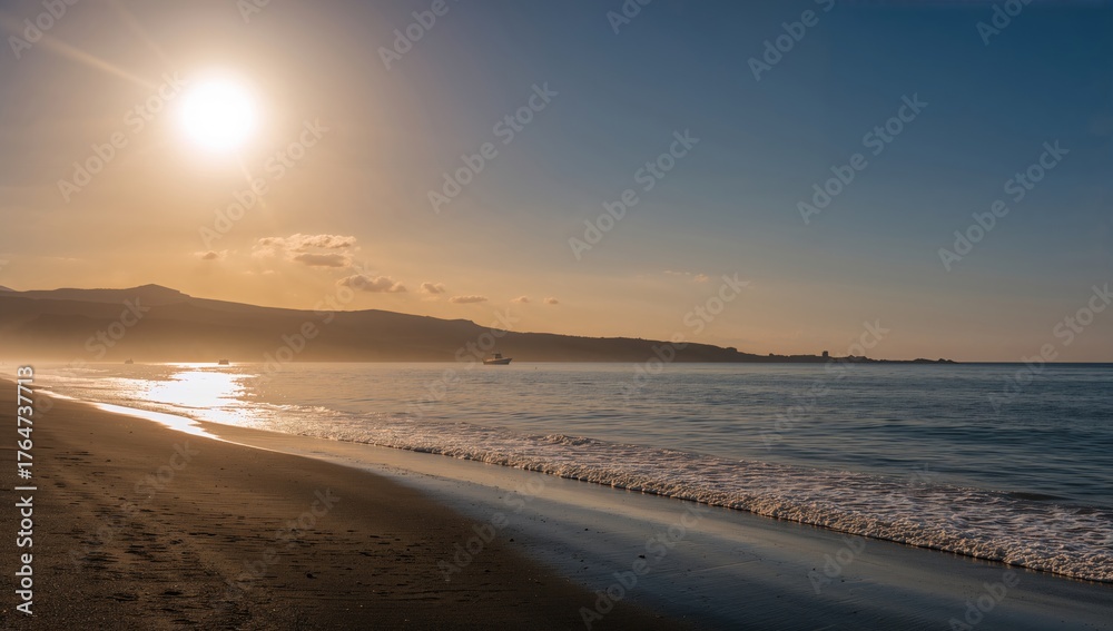 Obraz premium Radiant sunlight bathes dark volcanic sands on a hidden island beach, while cobalt waves softly touch the coastline. A peaceful September wind murmurs through the fresh sea air.