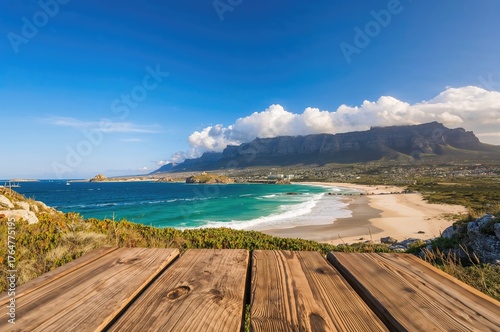 Ocean view with mountains and beach under blue sky