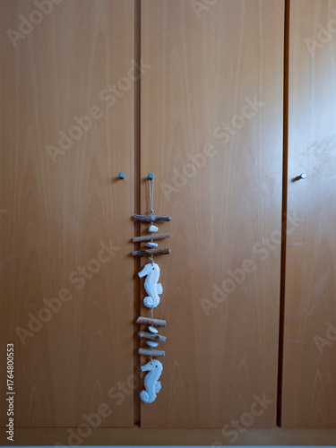 2.2 Hanging wooden photograph of sea-related figures in final position