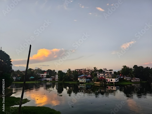 Serene twilight over a calm waterway reflecting a colorful sky