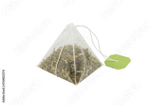 Pyramid tea bag with green tea isolated, herbal beverage in transparent bag with green label on no background PNG