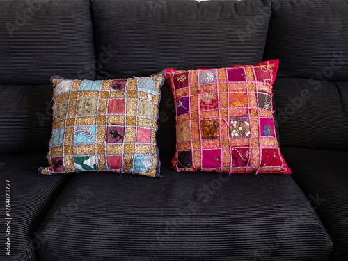 100.2 Photograph of Indian-themed cushions on a black sofa. Photograph replacing the objec