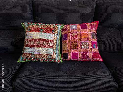 100.1 Photograph of Indian-themed cushions on a black sofa. Initial photo