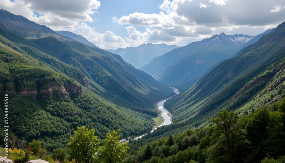 Naklejka premium Serene Mountain Valley with a Meandering River Under a Bright Blue Sky and Fluffy Clouds