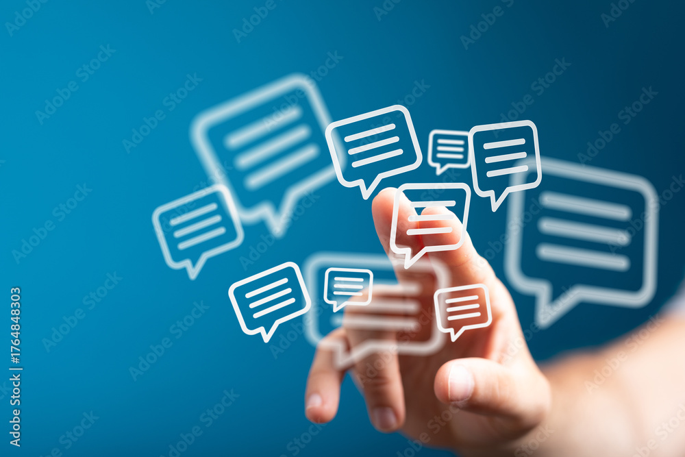 Obraz premium Hand interacting with digital chat bubbles. Represents messaging, social media, online conversations, networking, and the concept of global comm