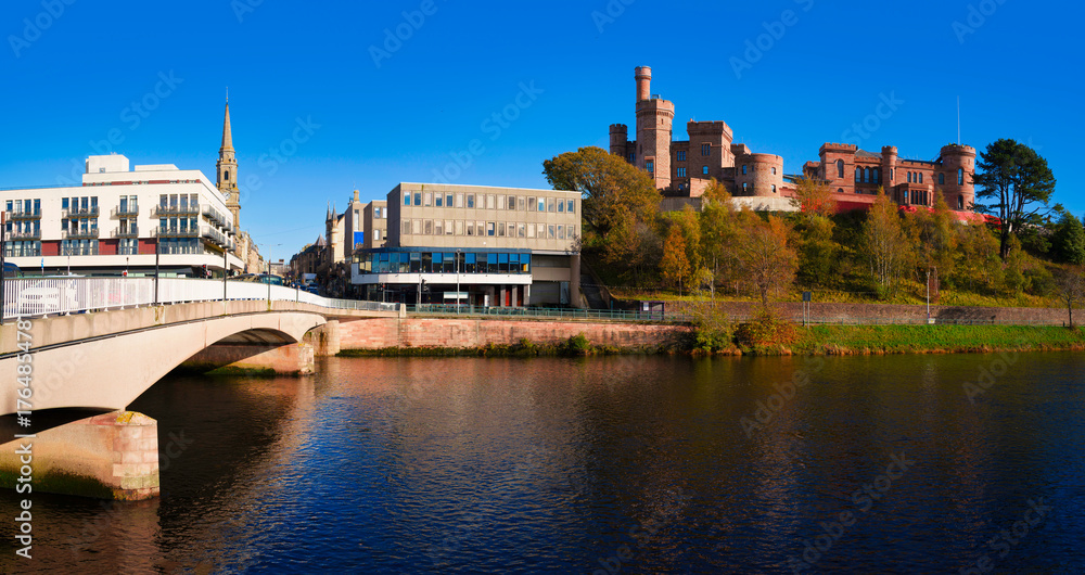 Fototapeta premium Inverness city skyline featuring Inverness Castle, modern buildings, and Ness Bridge over the River Ness in Scotland, United Kingdom.