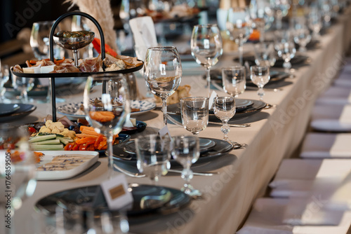 Elegant Wedding Reception Table Setting with Charcuterie, Wine Glasses, and Gray Linens: Luxurious Celebration Decor
