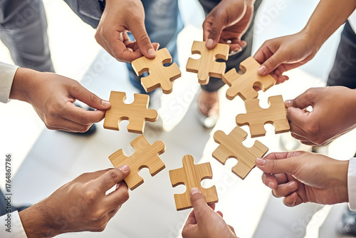 Company employees playing game and joining pieces of jigsaw puzzle during team building activity