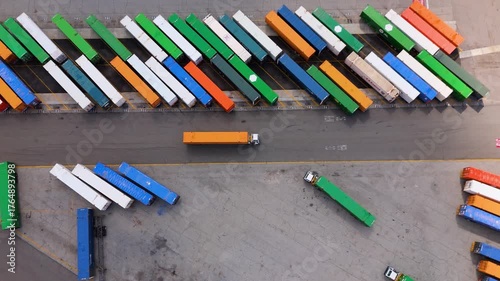 Top View of Orange Truck Leaving Parking Lot with Colorful Cargo Containers, October 7, 2025