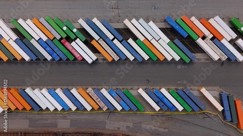 Top-down aerial view of colorful cargo containers in parking rows, October 7, 2025