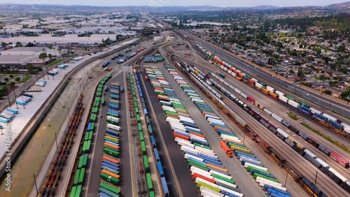 Aerial tilt-down view of cargo trains and containers at logistics terminal in October 7, 2025