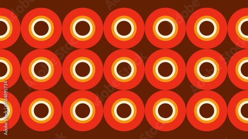 A seamless bold retro geometric pattern of concentric circles in warm orange, yellow, and brown tones. 1970 design vintage background.