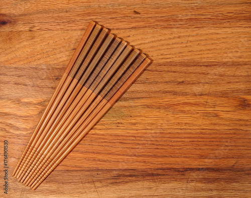 ten contemporary chopsticks on a wooden cutting board