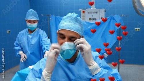 Scrub nurse arranging forceps, surgeon lowering mask while prepping surgery with multiplying hearts