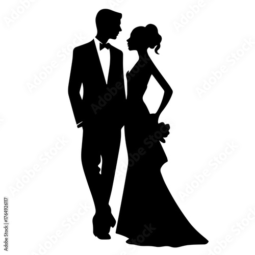 Silhouette of a groom in a tuxedo and a bride in a gown looking at each other on their wedding day