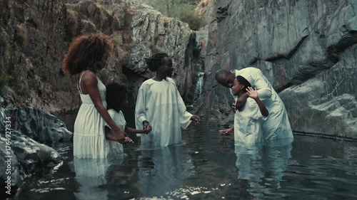 Ceremony pool baptism ritual in nature with family connections and joy