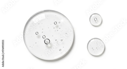Captivating clear serum droplets with air bubbles sparkle on white, perfect for cosmetic product advertising and skincare innovation.