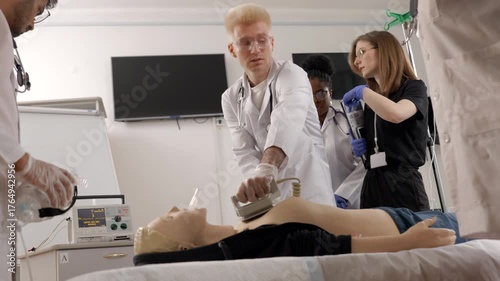 Medical students learning cpr techniques with a mannequin