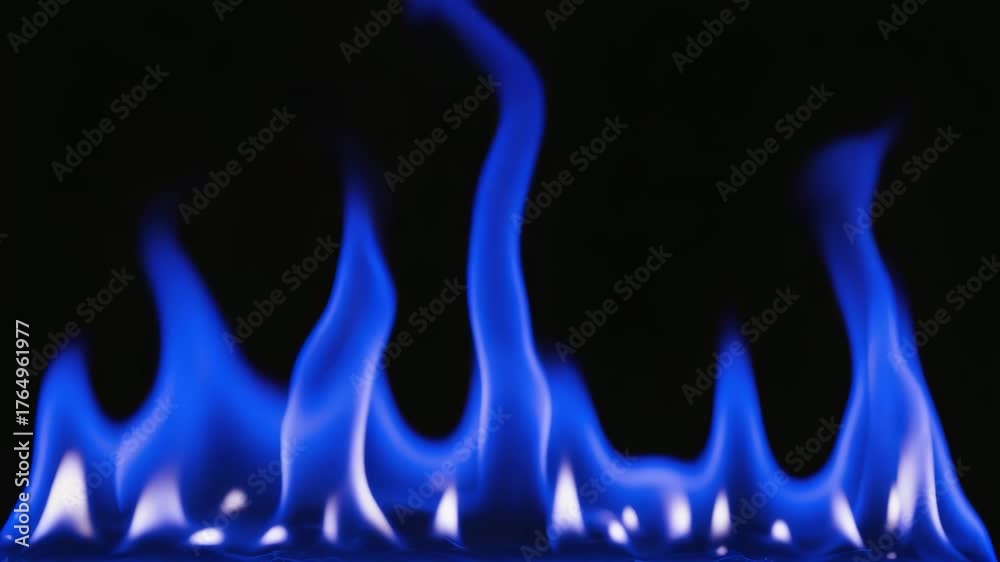 Closeup of bright blue fire flames isolated on black background