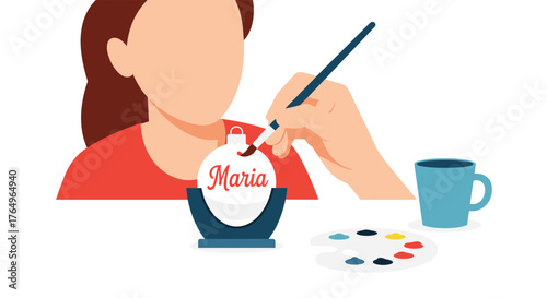 Creative person personalizing a holiday ornament with name 'Maria' using paint brush and color palette, celebrating DIY crafting joy and festive traditions