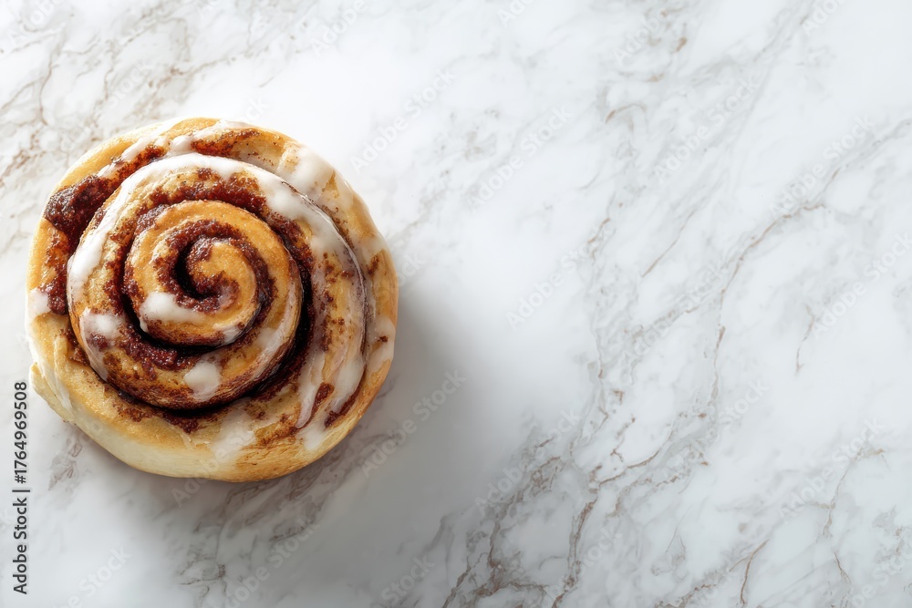 Fototapeta premium Delicious cinnamon roll with creamy glaze on light marble surface enhances sweet indulgence for dessert lovers and bakery enthusiasts. Perfect for food photography, recipes, and culinary presentations