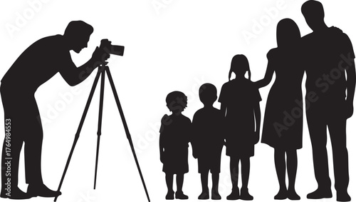 Silhouette of a photographer taking a picture of a family of four with a tripod camera