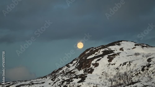 Full moon over the icy mountains in Northern Norway, in wild, untouched nature
