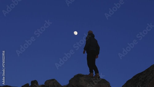 Man stands on the final rock above wild Arctic scenery in Northern Norway, alone with his thoughts