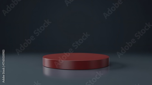 A single dark red cylindrical podium or pedestal stands on a reflective surface against a dark moody background