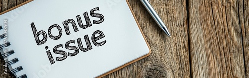 A handwritten note on a wooden table with the words bonus issue emphasizing creativity and personal touch.