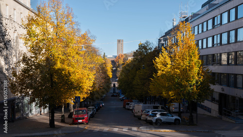 Urban street in Finland with yellow autumn trees and Nordic architecture